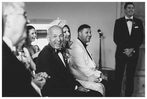 Father of the bride laughing during ceremony